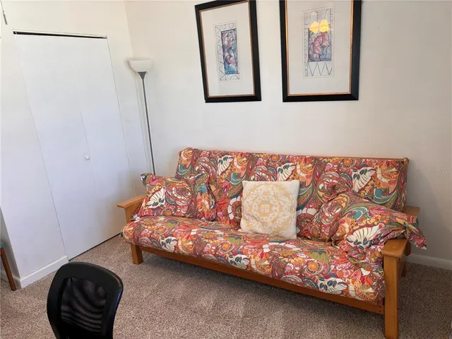 a bedroom with a bed and painting on the wall