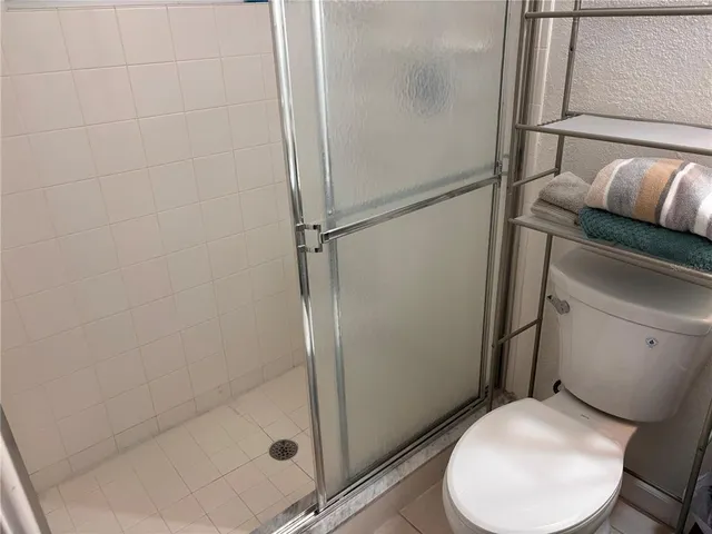 a white toilet sitting next to a bathroom sink