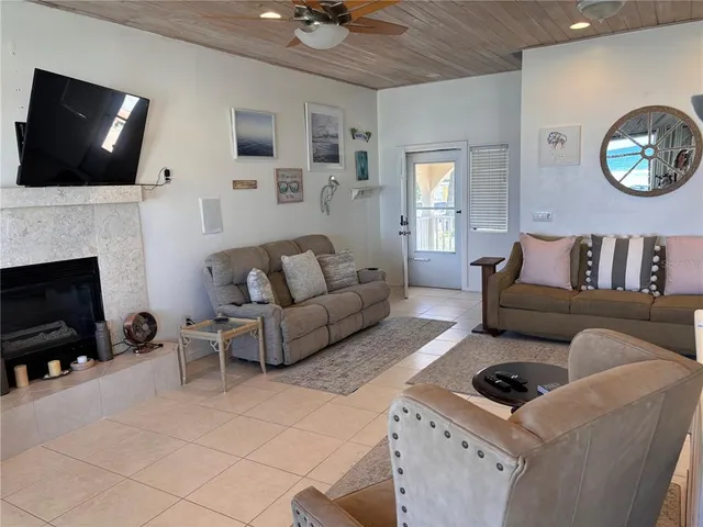 a living room with furniture a fireplace and a flat screen tv