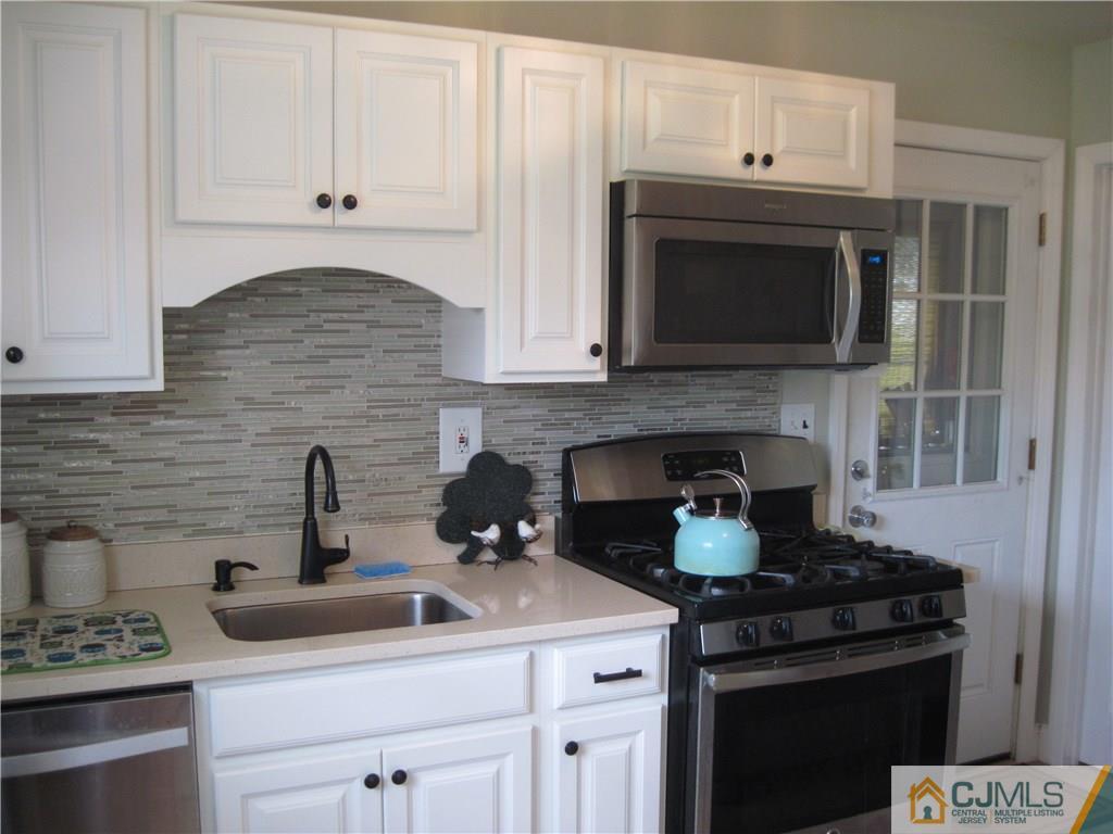 17 Georgetown Road Old Bridge, NJ 08859 - Photo 2 of 12 a kitchen with a stove and cabinets
