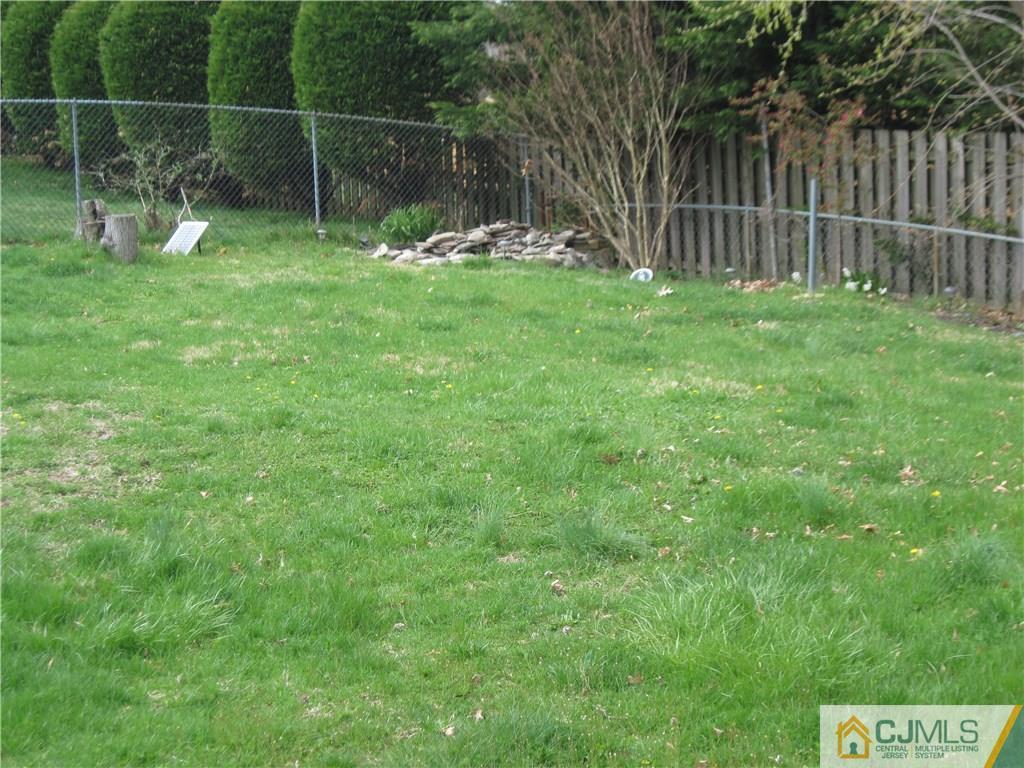 17 Georgetown Road Old Bridge, NJ 08859 - Photo 11 of 12 a backyard of a house with plants and outdoor seating