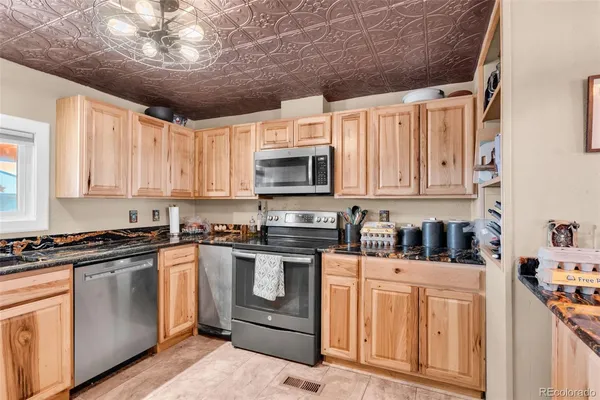a kitchen with stainless steel appliances granite countertop a stove sink microwave and cabinets