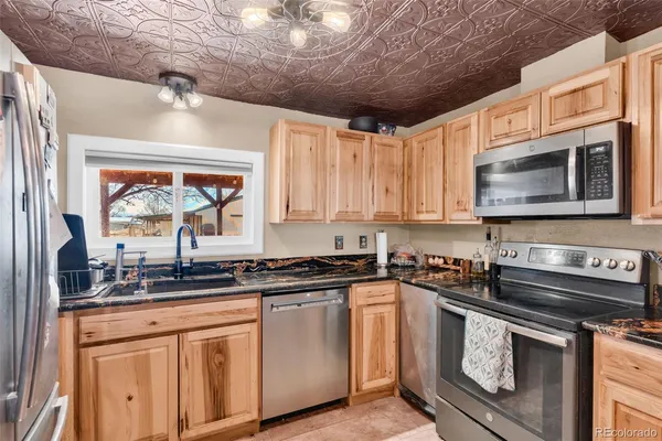 a kitchen with stainless steel appliances wooden cabinets and a sink