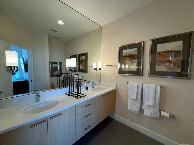 a bathroom with a double vanity sink and mirror