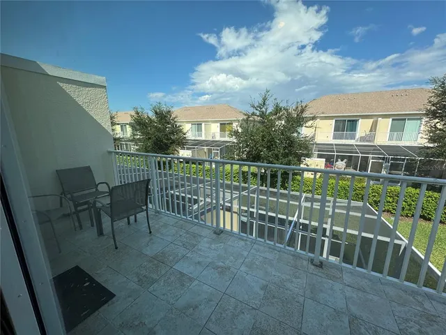 a view of a chairs and table in patio