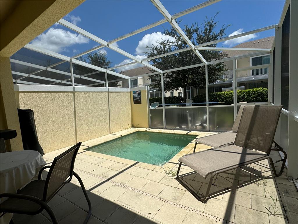 1641 Retreat Circle Clermont, FL 34714 - Photo 16 of 16 a view of a patio with table and chairs and potted plants