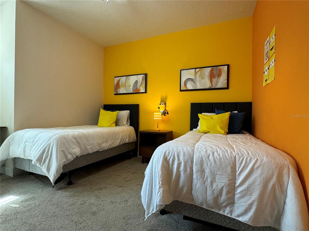 1641 Retreat Circle Clermont, FL 34714 - Photo 6 of 16 a bedroom with a bed and wall painting