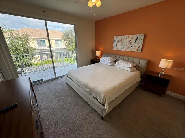 a bed sitting in a bedroom next to a window