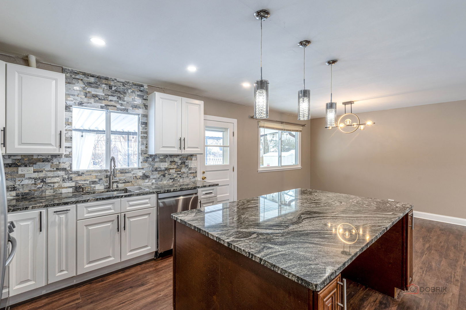 681 South Mt Prospect Road Des Plaines, IL 60016 - Photo 12 of 20 a kitchen with granite countertop kitchen island white cabinets and wooden floor