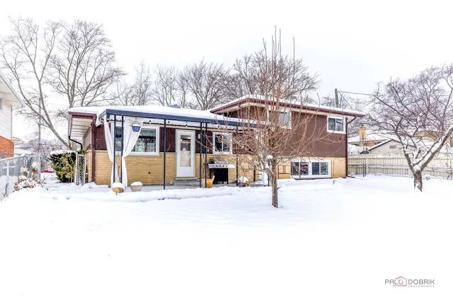 a view of a house with a snow in the yard