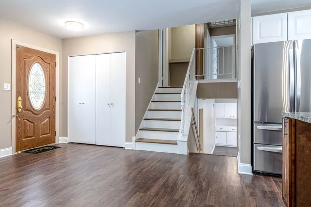 a view of a kitchen with wooden floor and electronic appliances