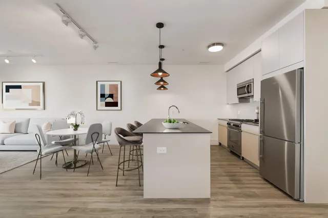 a kitchen with granite countertop a sink appliances and cabinets