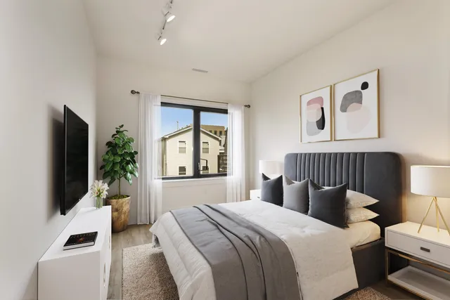 a bedroom with a large bed and a flat screen tv