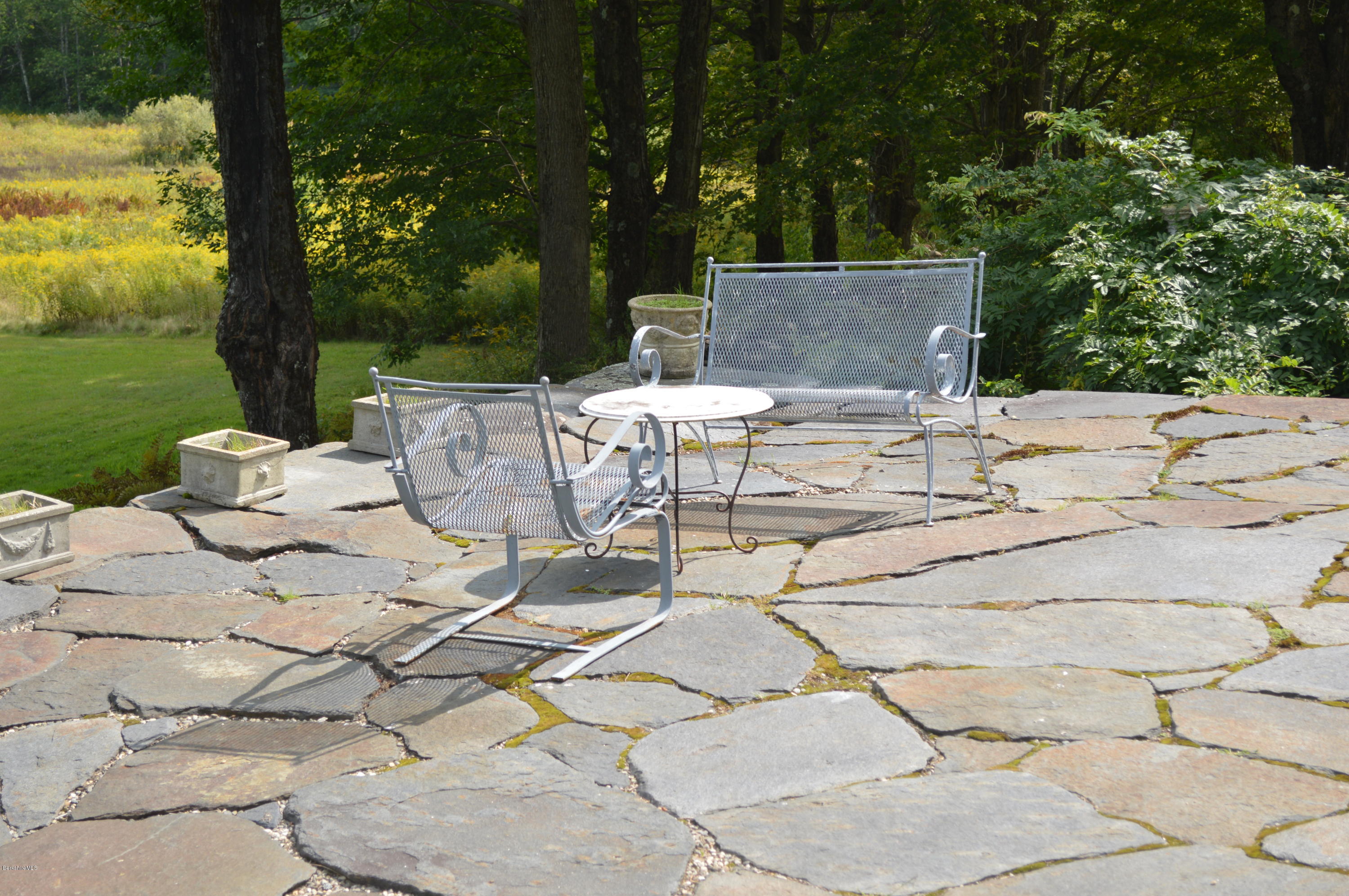 128 Chipman Road Middlefield, MA 01011 - Photo 12 of 61 a view of a patio with table and chairs with wooden floor and fence