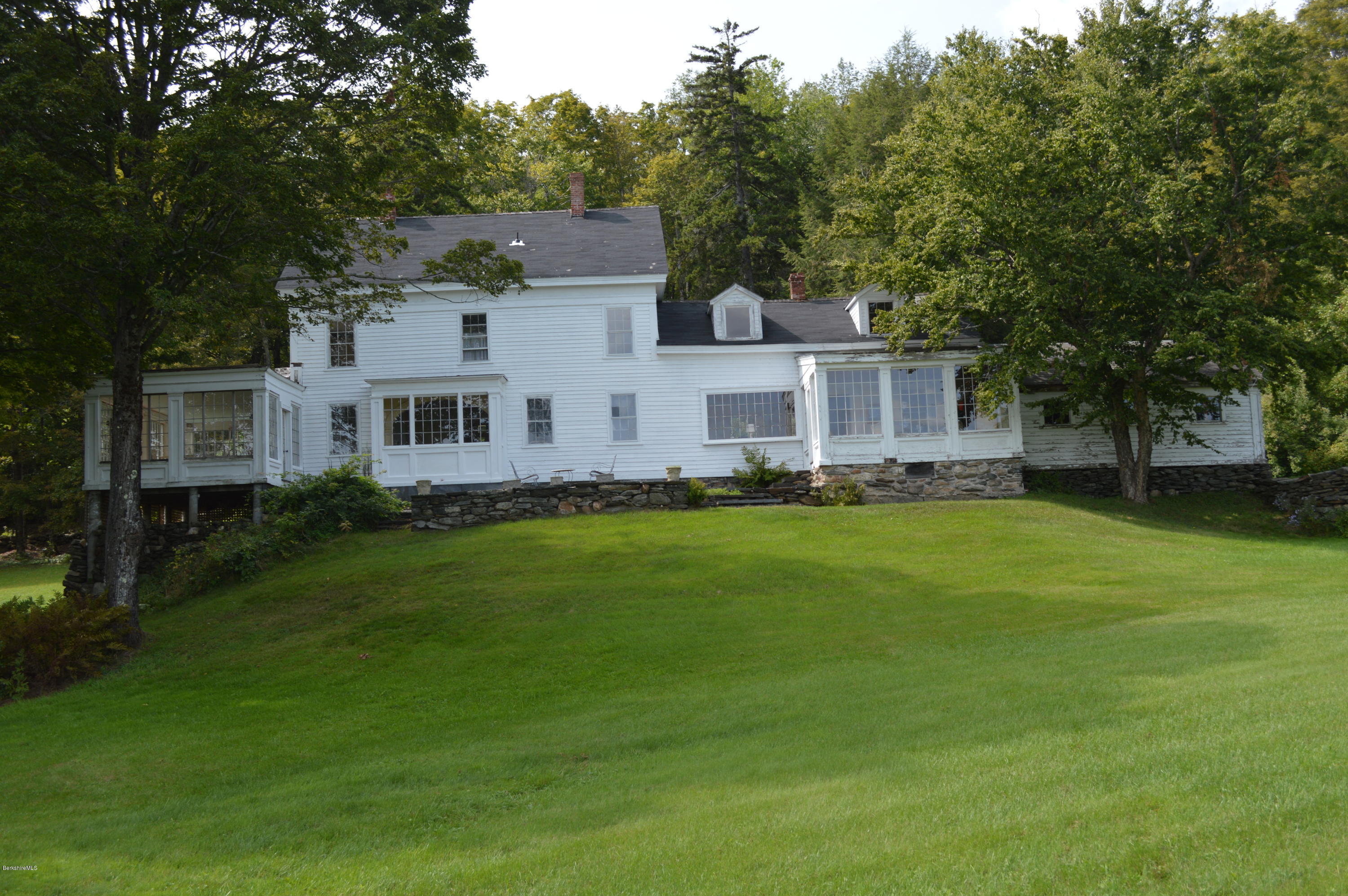 128 Chipman Road Middlefield, MA 01011 - Photo 14 of 61 a front view of a house with a garden and trees