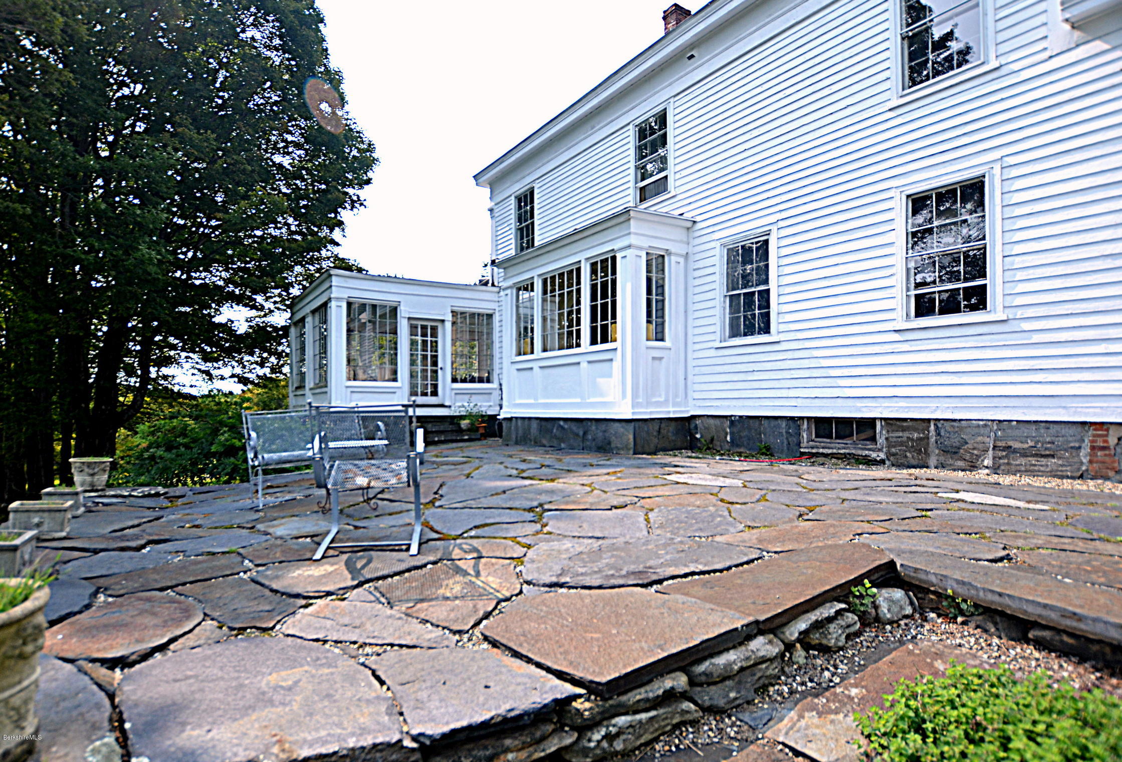 128 Chipman Road Middlefield, MA 01011 - Photo 54 of 61 a view of a patio with table and chairs and wooden fence