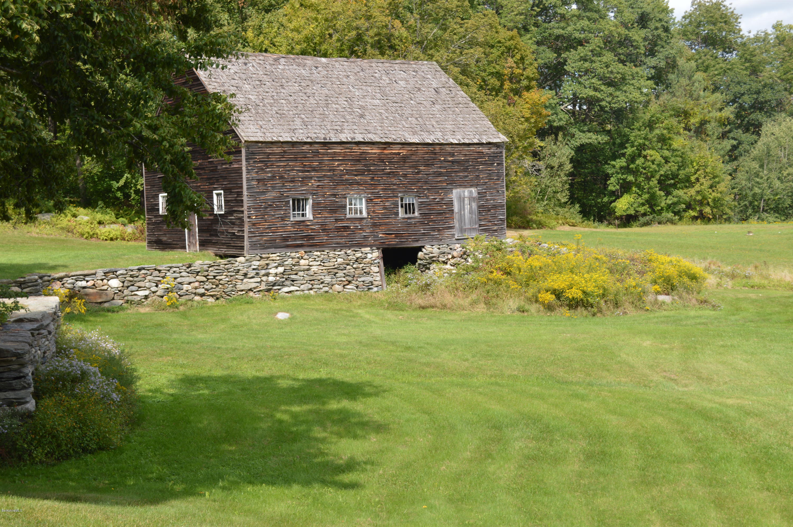 128 Chipman Road Middlefield, MA 01011 - Photo 60 of 61 a view of an house with a yard