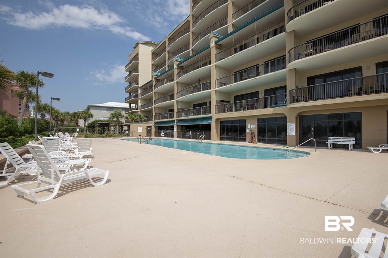 27284 Gulf Road, Unit 213 Orange Beach, AL 36561 - Photo 5 of 40 Large sunning area around the pool.