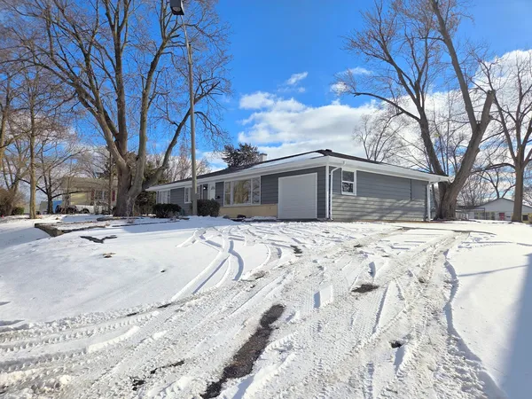 a view of house with snow on the road