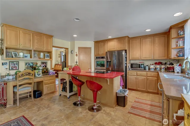a large kitchen with lots of counter space and windows