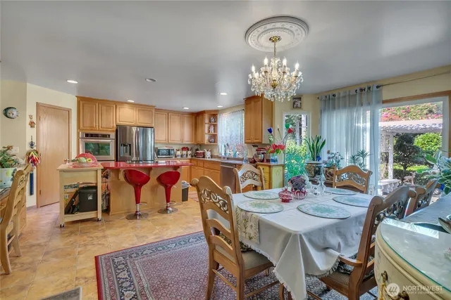 a view of a dining room with furniture and a chandelier