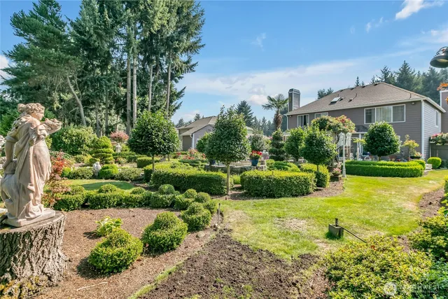 a view of a garden with an buildings and fence