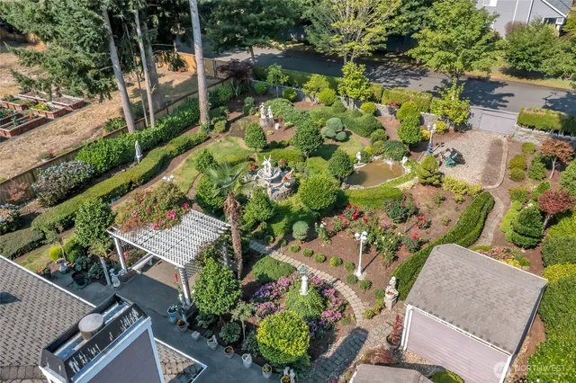 an aerial view of a house with a yard and garden