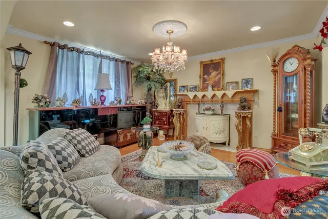 a living room with furniture and a chandelier