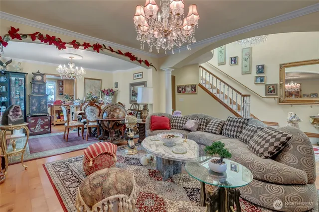 a living room with furniture and a chandelier