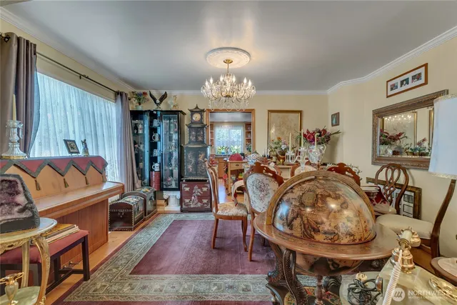 a view of a dining room with furniture a chandelier and wooden floor