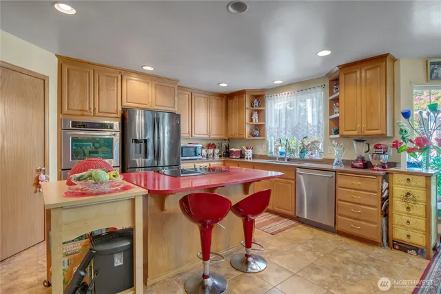 a kitchen with a sink refrigerator and cabinets