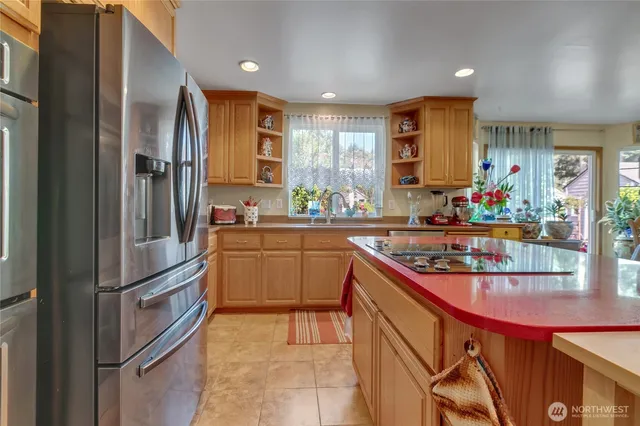a kitchen with stainless steel appliances granite countertop a refrigerator and a sink