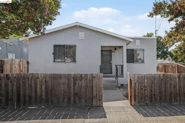 a view of a house with wooden fence