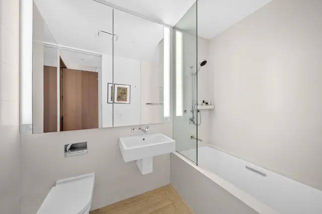 a spacious bedroom with a bed and a large window