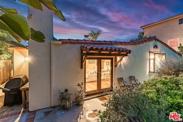 a backyard of a house with table and chairs