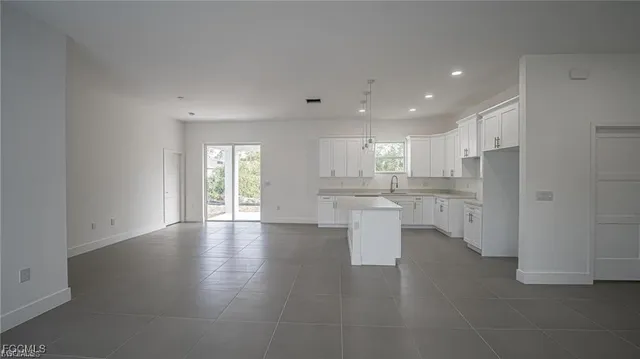 a view of kitchen with refrigerator and window