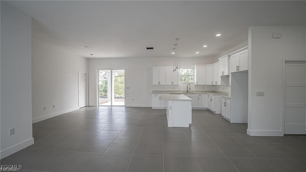 744 Clancy Street East Lehigh Acres, FL 33974 - Photo 4 of 14 a view of kitchen with refrigerator and window
