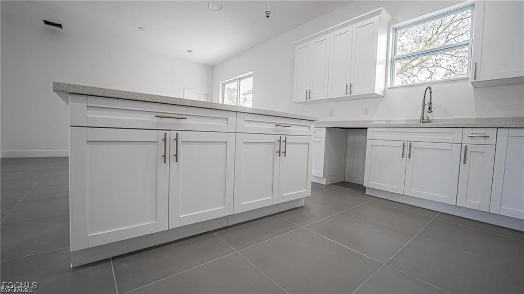 744 Clancy Street East Lehigh Acres, FL 33974 - Photo 5 of 14 a view of cabinets a window and a kitchen