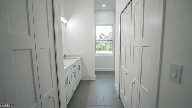 a bathroom with a double vanity sink and a window