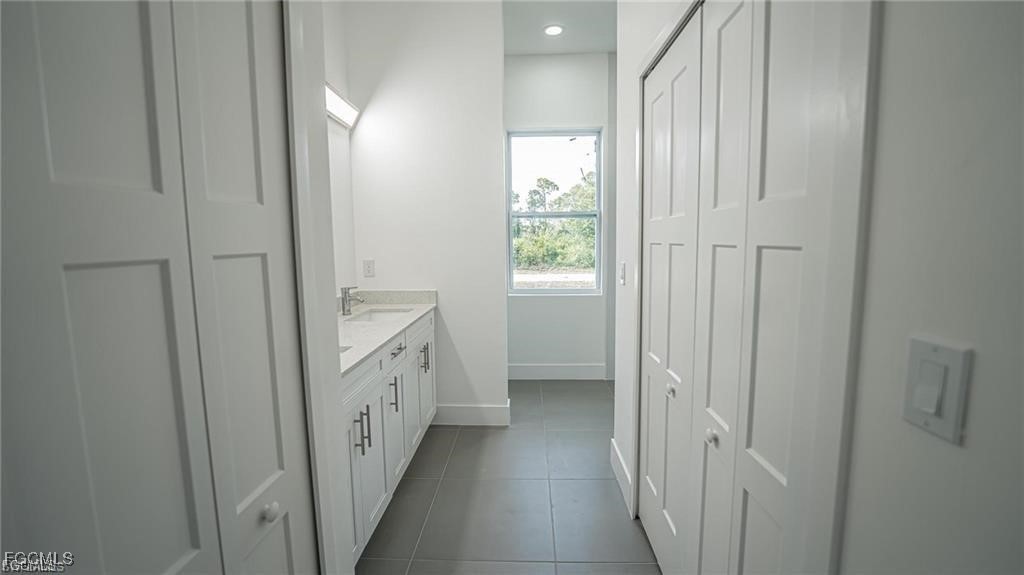 744 Clancy Street East Lehigh Acres, FL 33974 - Photo 6 of 14 a bathroom with a double vanity sink and a window