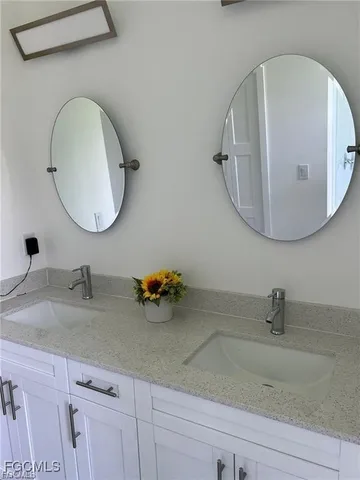a bathroom with a sink and mirror