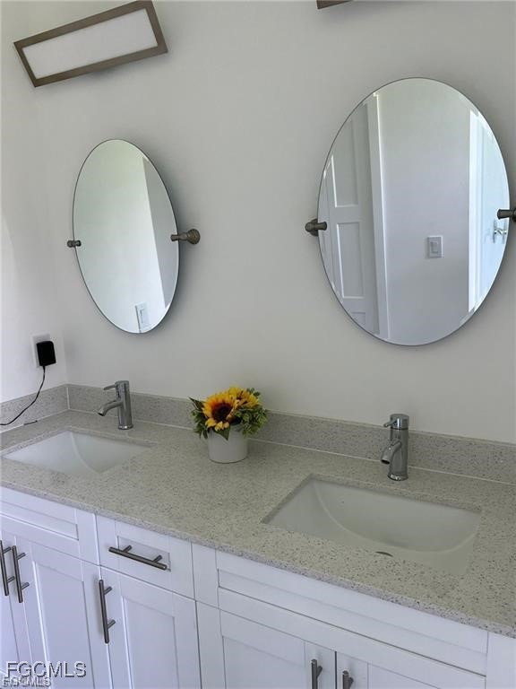 744 Clancy Street East Lehigh Acres, FL 33974 - Photo 7 of 14 a bathroom with a sink and mirror