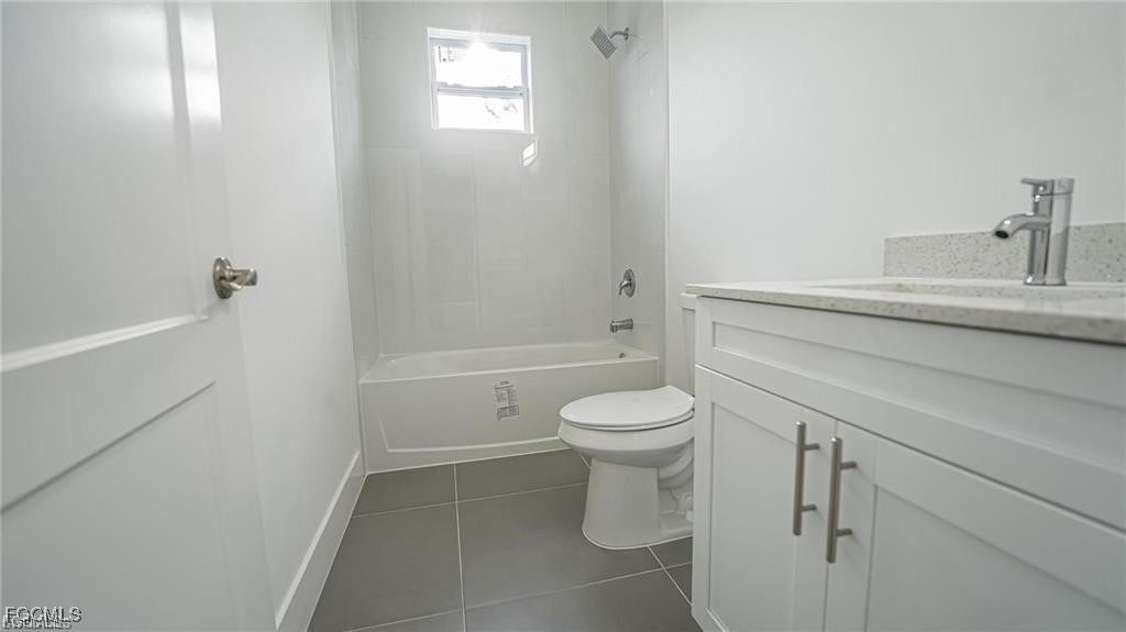 744 Clancy Street East Lehigh Acres, FL 33974 - Photo 10 of 14 a bathroom with a sink a toilet and shower