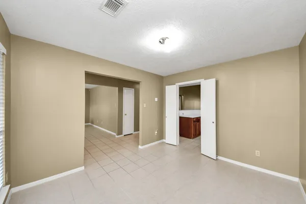 an empty room with an entrance to other room