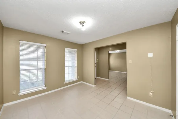 an empty room with windows and closet