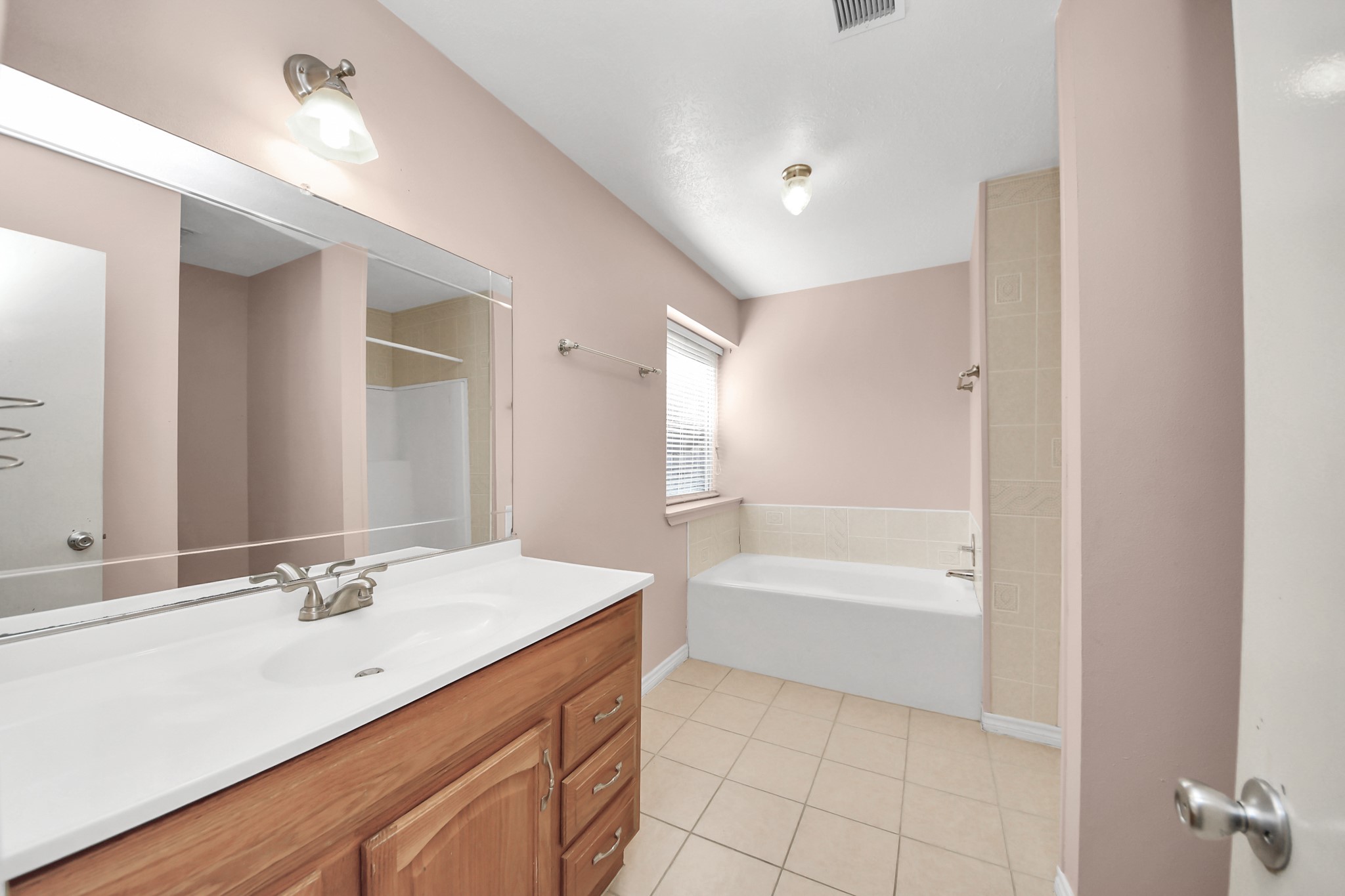 3310 Keygate Drive Spring, TX 77388 - Photo 26 of 45 a bathroom with a tub sink double vanity and tub