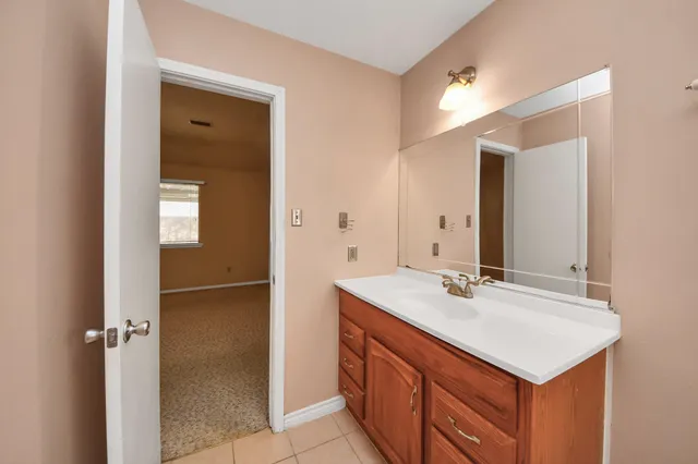 a bathroom with a sink a mirror and shower
