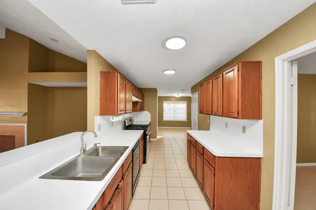 a large bathroom with a double vanity sink mirror and bathtub