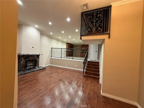 an empty room with wooden floor and mirror