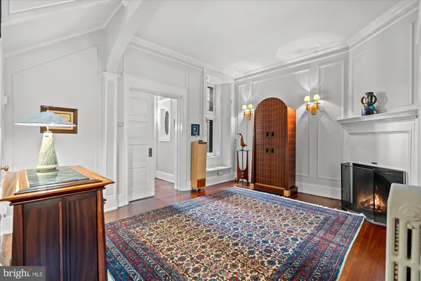 a dining room with furniture a chandelier and wooden floor